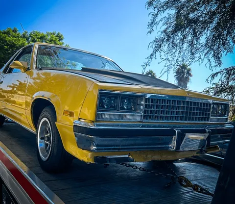 Classic car tow of a yellow coupe in Norwalk, CA by Carsaad Towing