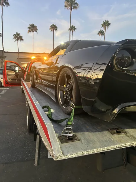 Sports car loaded on a flatbed at sunset in Brea, CA by Carsaad Towing