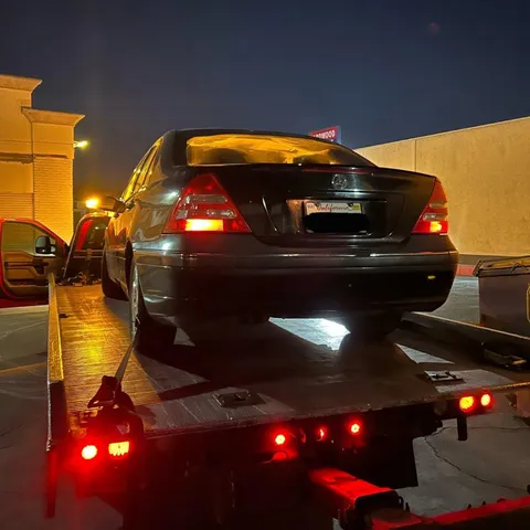 Tow truck securing a stalled car for transport in Anaheim, California.