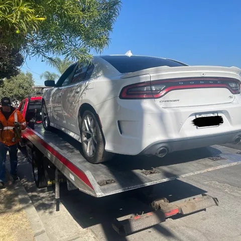 Tow truck dropping off non-running car after breakdown tow in Bellflower California