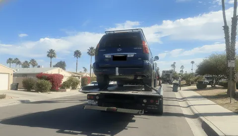 Blue van being towed on highway in Garden Grove California morning
