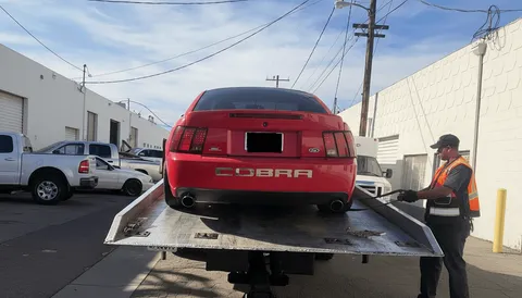 Tow truck driver adding fuel during roadside assistance in Huntington Beach California